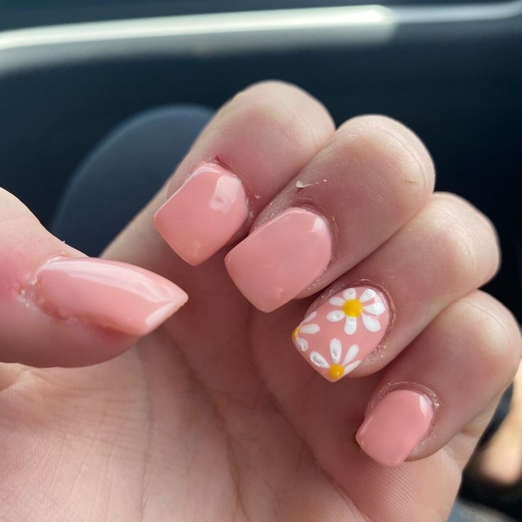 Elegant Pastel Pink Nail Design with Playful White Daisy Accents