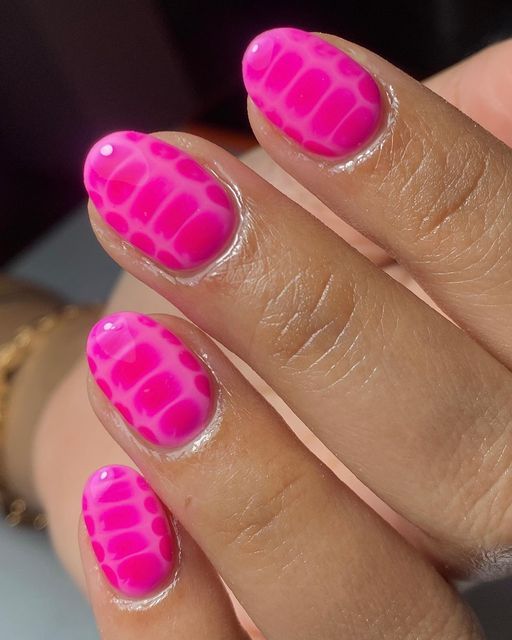 Bold Vibrant Pink Nail Design with Textured Pattern and Glossy Finish for a Trendy Manicure.