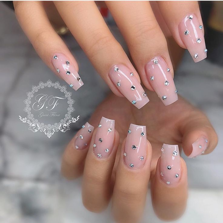 Chic Elegant Nude Nails with Shimmering Rhinestones for a Glamorous Look.