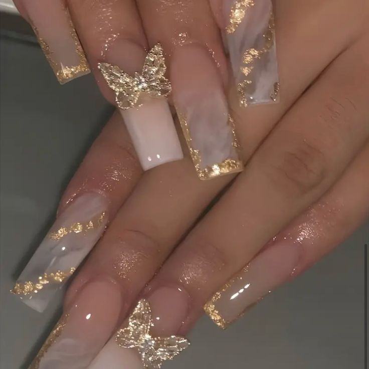 Elegant Pastel Marble Nail Design with Gold Accents and Whimsical Butterfly Embellishments