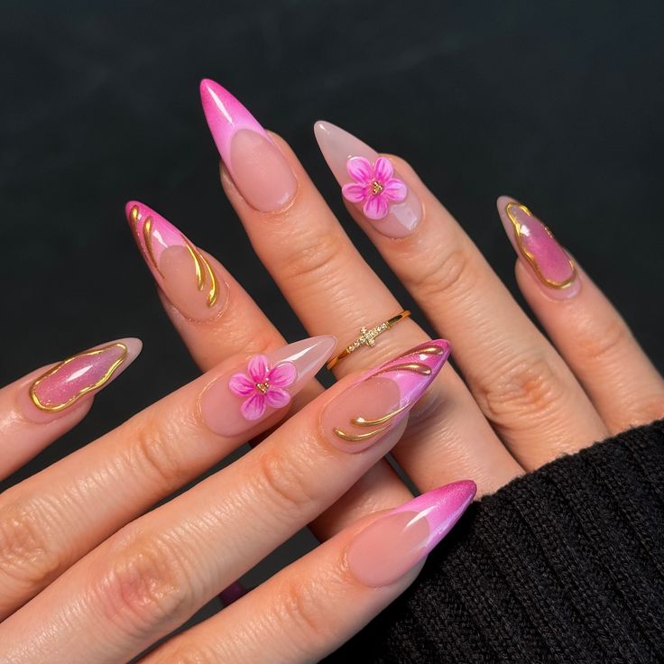 Chic Almond-Shaped Ombre Nails with Floral Accents and Gold Detailing.