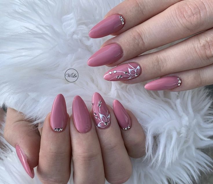 Chic Elegant Pink Almond Nails with Glossy Finish and Floral Gems Accents.