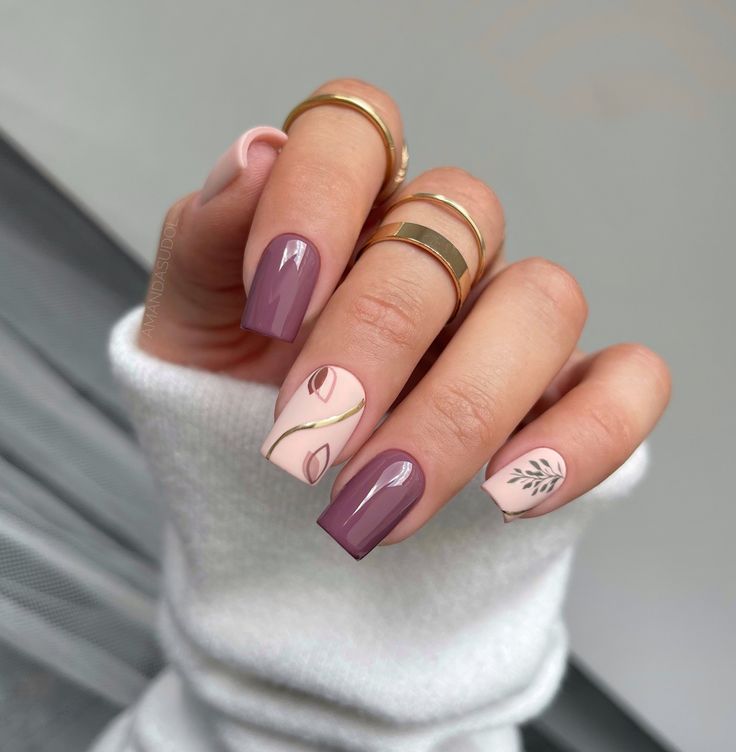 Chic Pastel and Mauve Nail Design with Delicate Leaf Patterns and Dainty Rings.