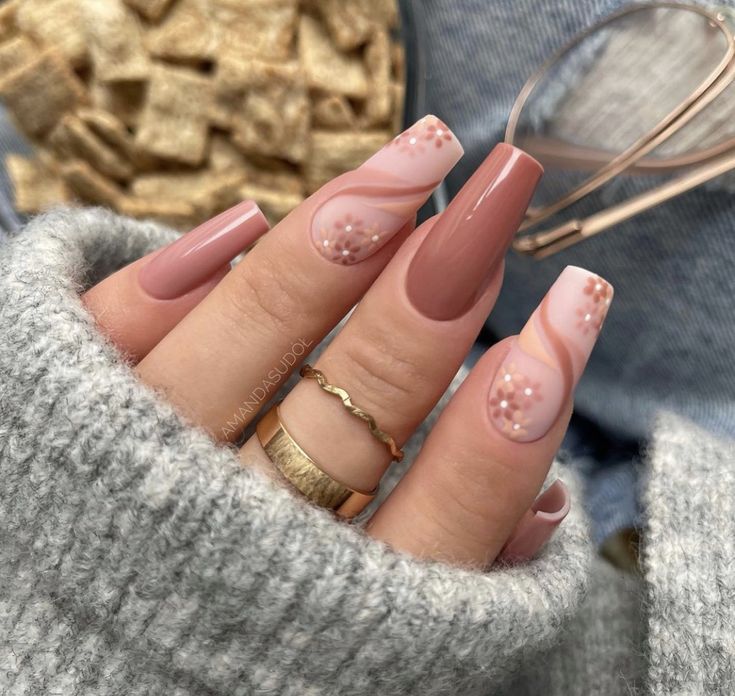 Elegant Nude and Blush Nail Design with Abstract Patterns and Dot Embellishments