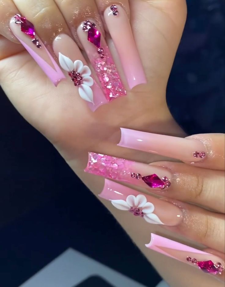 Elegant Soft Pink Gradient Nails with Intricate Designs and Sparkling Gems.