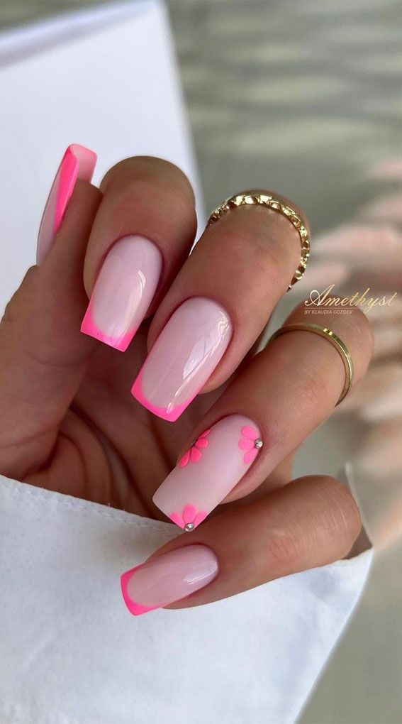 Chic Floral Nail Design: Soft Pink Base with Vibrant Hot Pink Tips and Sparkling Rhinestones.