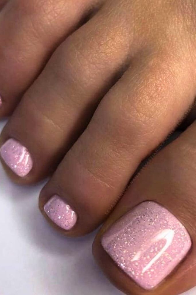 Elegant Pink Pedicure with Subtle Glitter for All Occasions