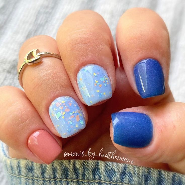 Vibrant Nail Design with Pastel Blue and Navy, Sparkling Confetti, and Soft Pink Accent.