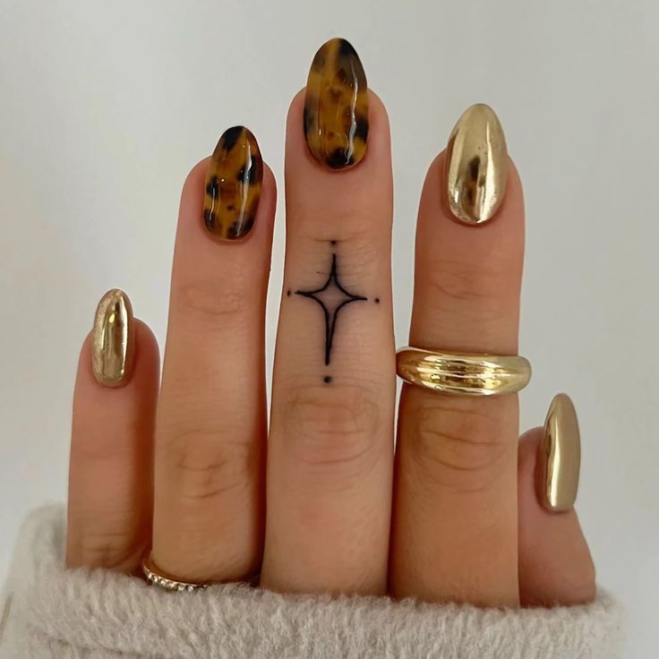 Chic Almond-Shaped Nail Design with Gold Metallic Finish and Tortoiseshell Accents