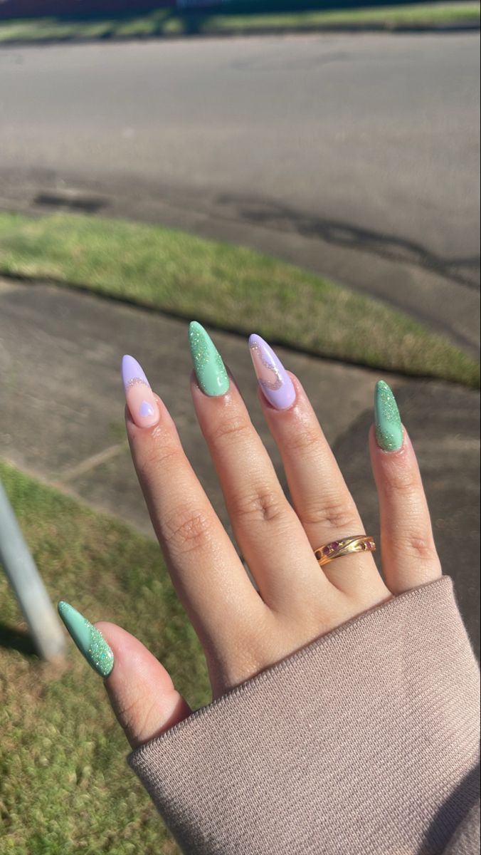 Vibrant Mint Green and Lavender Nail Design: A Trendy Blend of Sparkle and Minimalism.