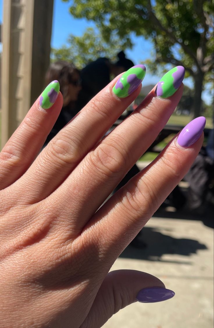 Vibrant Green and Purple Abstract Nail Design for a Bold Artistic Statement.