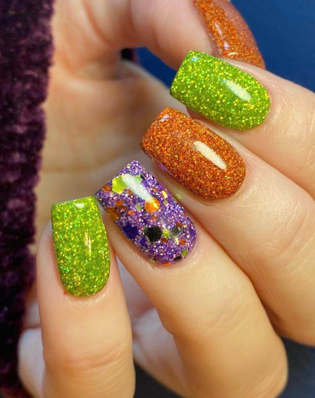 Playful Vibrant Nail Design with Sparkling Green, Orange, and Glittery Multi-Colored Accent.