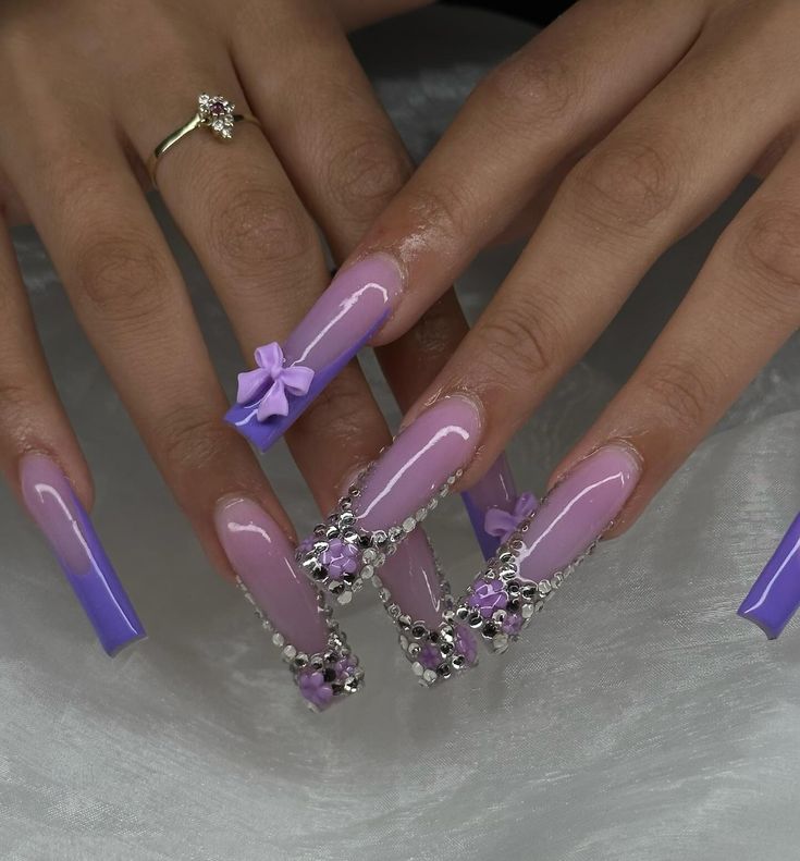 Striking Lavender Nail Design with Glamorous Embellishments and Elegant Finishes.