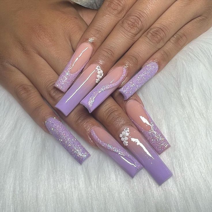 Elegant Lavender Ombre Nails with Glitter and White Embellishments for Sophisticated Glamour.