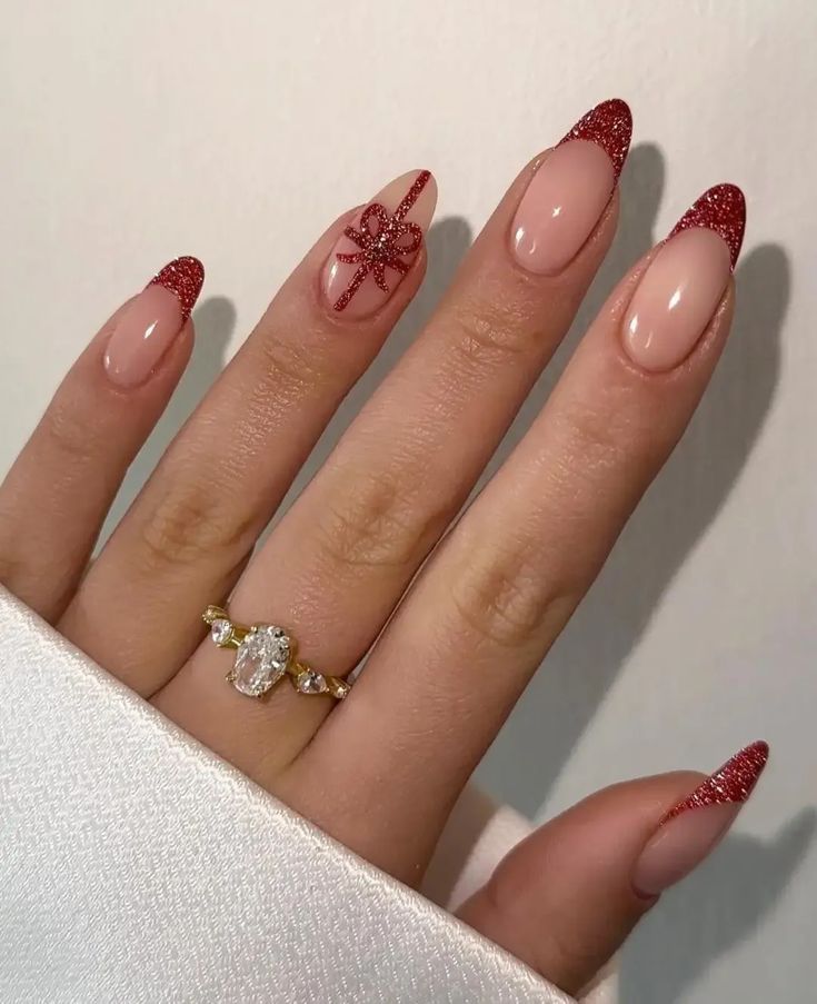 Chic Nude and Glittery Red Nail Design with Geometric Accent for Special Occasions.