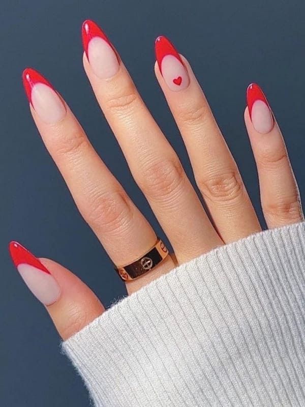 Chic Red Tip Nails with Subtle Heart Accent for a Modern Look.