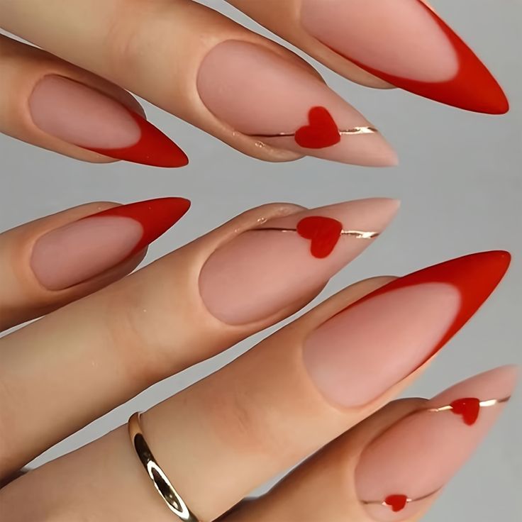 Charming Stiletto Nails: Sophisticated Red and Nude Design with Heart Accents and Gold Lines