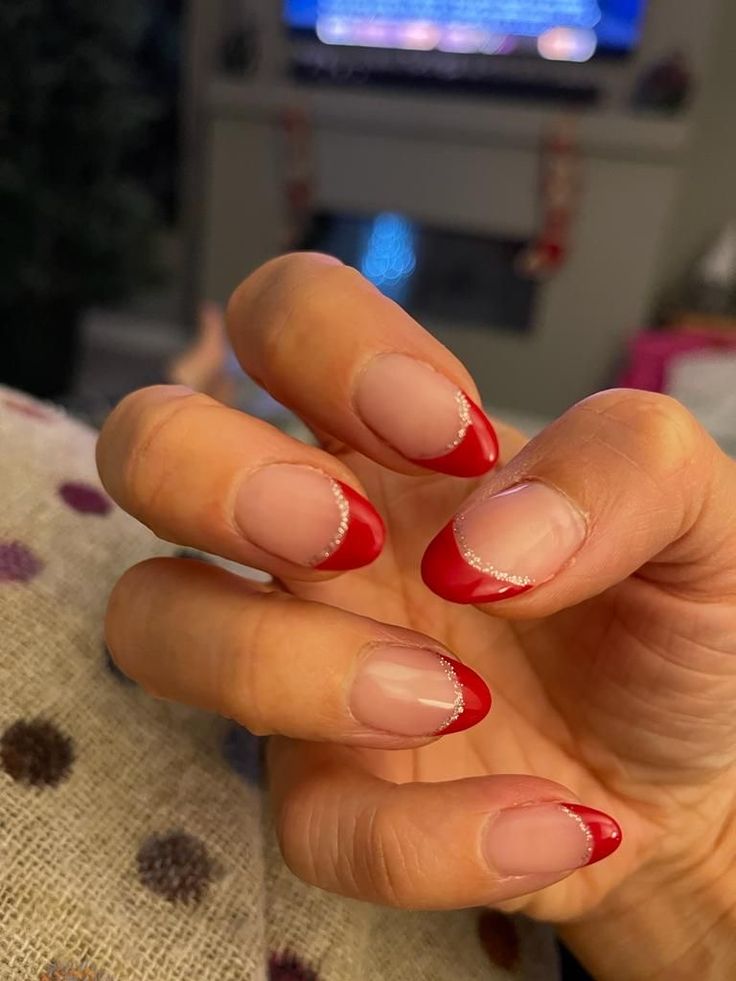 Chic French Tip Manicure with Glossy Red Tips and Silver Accents