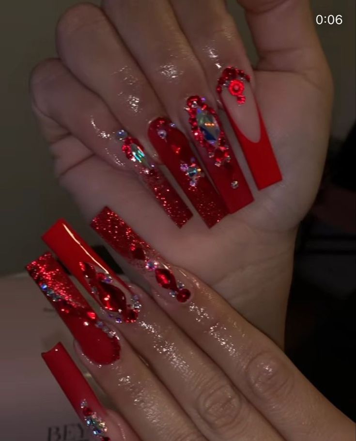 Striking Bold Red Nail Art with Glossy Finish, Glitter, and Rhinestone Details