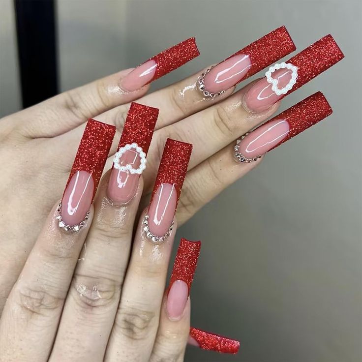 Elegant Sparkling Red Stiletto Nail Design with Romantic Accents.