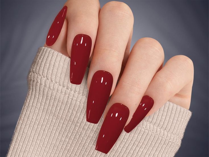 Elevate Your Style: Bold Long Red Nails Perfectly Complement Cozy Knitwear.