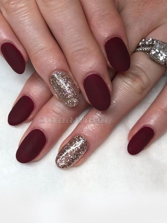 Chic Deep Burgundy Matte Nail Design with Gold Glitter Accent for Sophisticated Elegance.