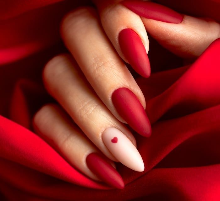 Elegant Red Matte Nails with Romantic Heart Accent Design