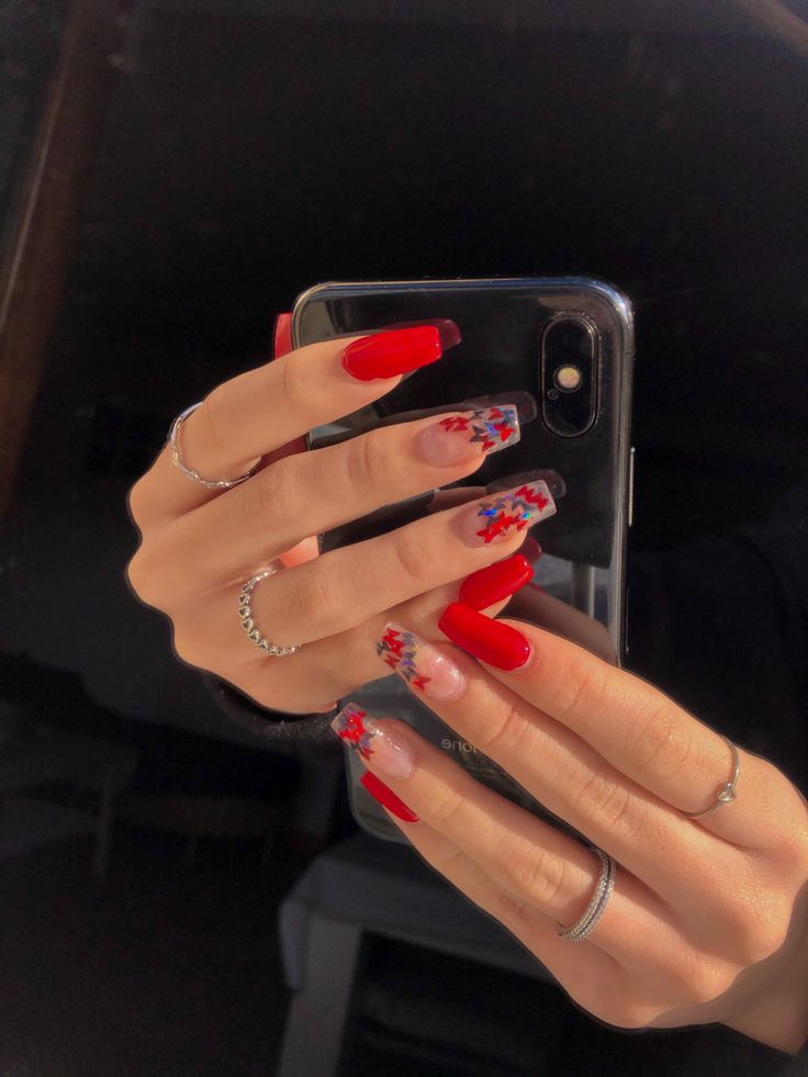 Bold Red Nails with Intricate Colorful Designs for a Standout Look.