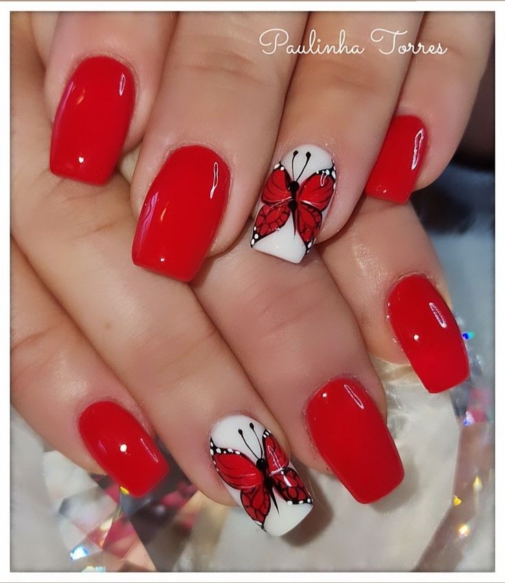 Playful Elegant Red Nail Design with Glossy and Matte Finishes Featuring Butterfly Art.