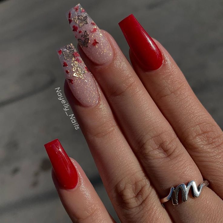 Stunning Bold Red Nails with Glitter and Floral Accents for a Creative Statement.