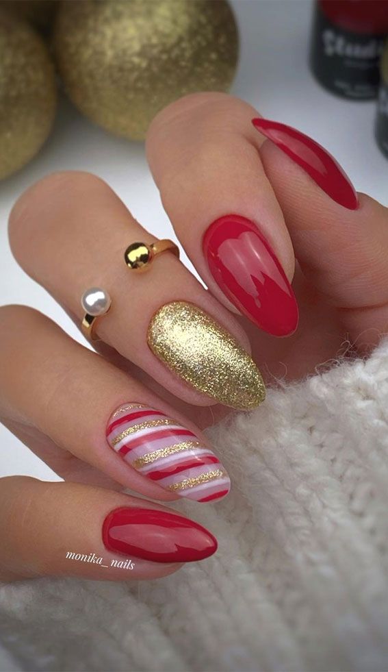 Luxurious Red and Gold Holiday Nail Design with Glitter, Stripes, and Elegant Embellishments.