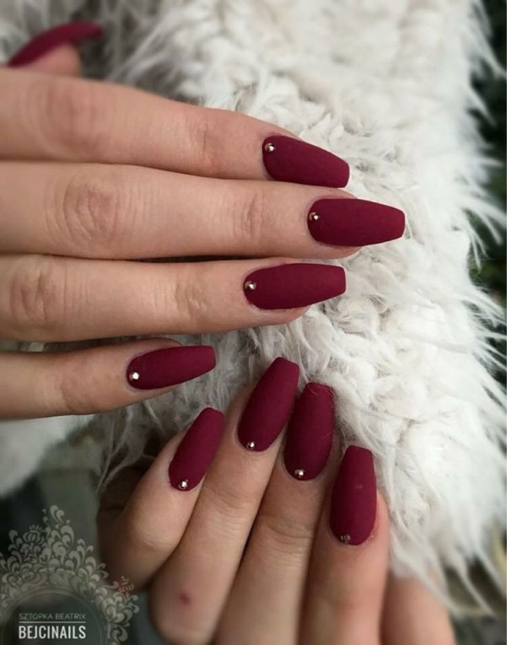 Sophisticated Burgundy Matte Nails with Glamorous Accents for Any Occasion.