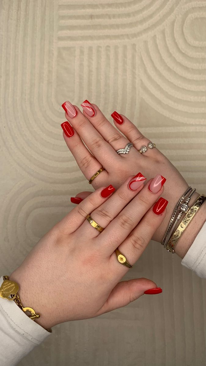 Elegant Bold Red and Soft Nude Ombre Nails with Chic French Tips and Delicate Rings.