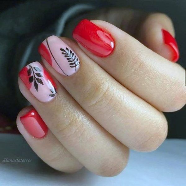 Chic Nail Design: Vibrant Red and Soft Pink with Elegant Black Leaf Accents.