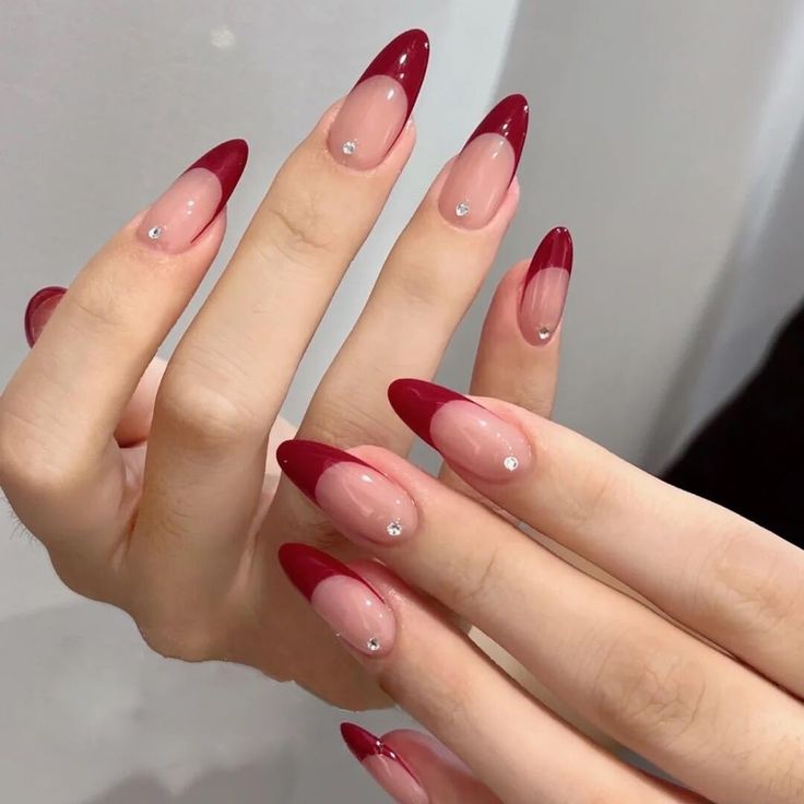 Elegant Gradient Burgundy Nail Design with Nude Tones and Gemstone Accents.