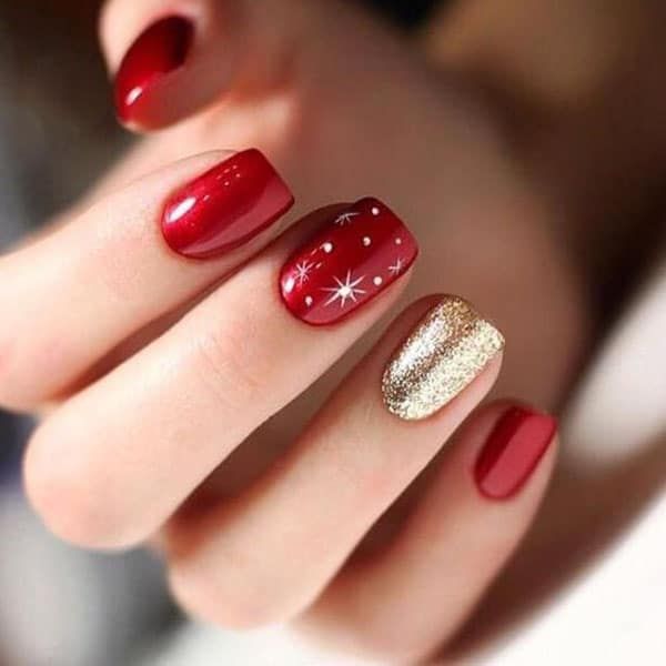 Festive Red and Glittery Gold Nail Design for Glamorous Occasions.