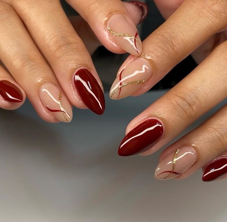 Elegant Geometric Nail Design with Burgundy, Nude, and Gold Accents.