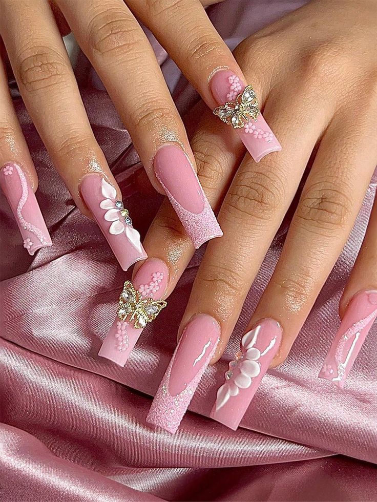 Elegant Floral Nail Art in Soft Pink with Intricate Embellishments.