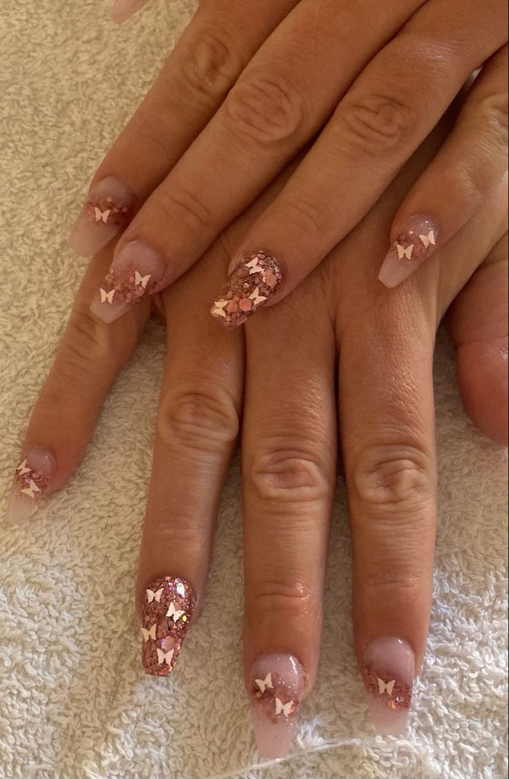 Elegant Glittering Butterfly Nail Design in Soft Pink and Rose Gold.