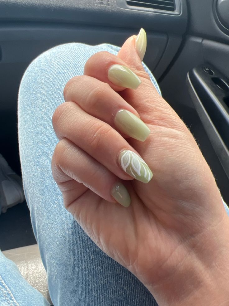 Elegant Pastel Green Nail Design with Artistic White Floral Accent