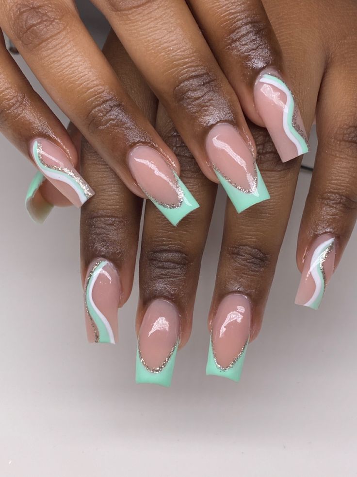 Chic Pastel Nail Design with Mint Green, Nude, Wavy Patterns, and Silver Accents.