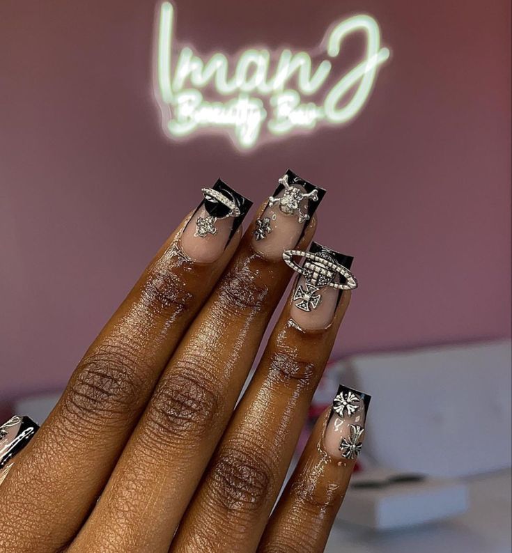 Elegant Black-Tipped Nail Design with Intricate Silver Charms