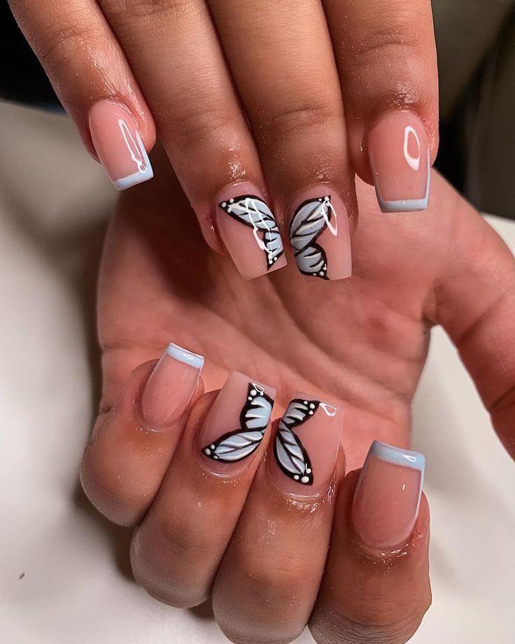 Whimsical Butterfly Nail Design with Elegant Nude Base and Fresh Baby Blue Tips.