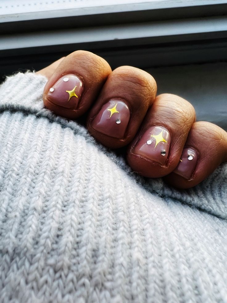 Elegant Chic Nude Nail Design with Whimsical Star and Rhinestone Accents.