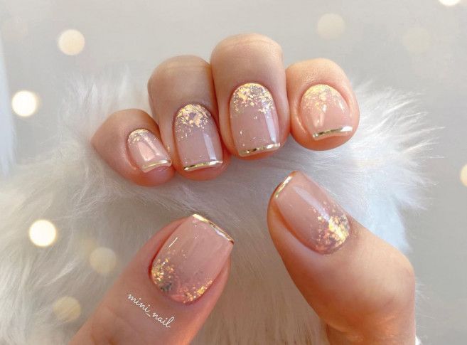 Sophisticated Nude and Gold Glitter Nail Design for Versatile Elegance.