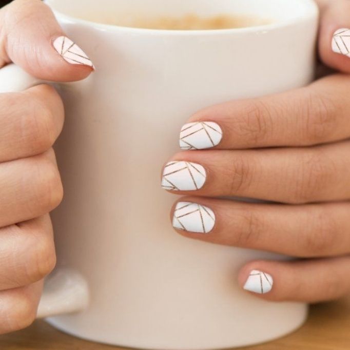 Chic Geometric Nail Design: Elegant White Base with Delicate Gold Lines.