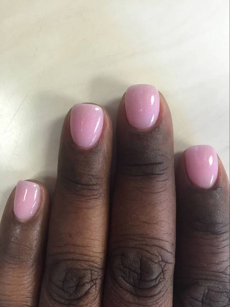 Elegant Delicate Pink Nails with Glossy Finish and Feminine Rounded Shape.