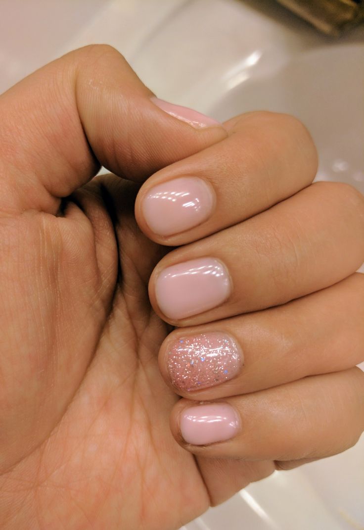 Elegant Soft Nude Nail Design with Sparkly Accent and Glossy-Glitter Contrast.