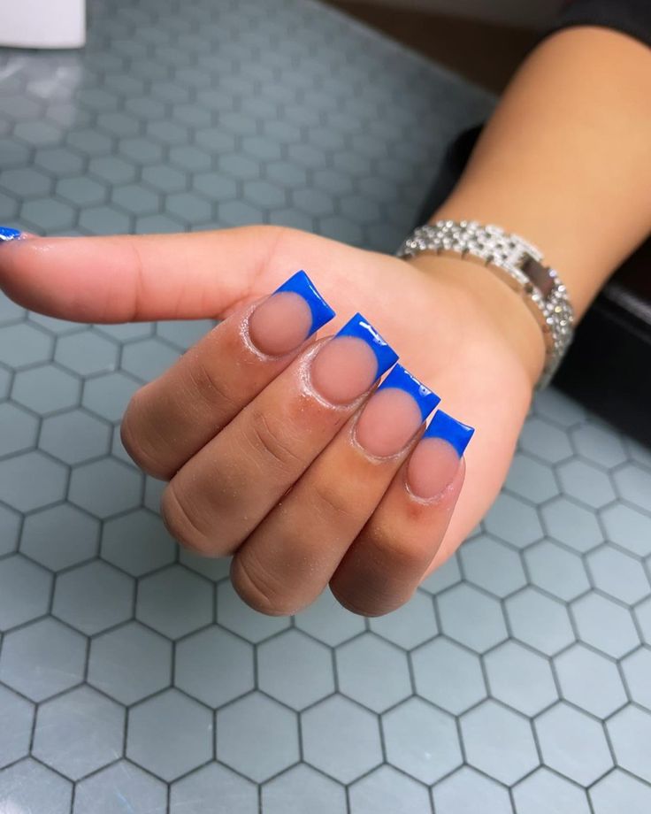 Modern French Manicure: Vibrant Blue Tips with Geometric Elegance