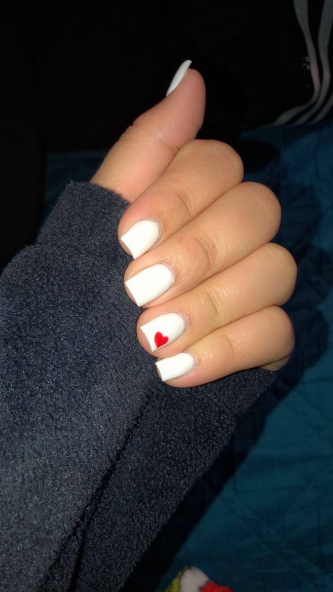 Elegant Matte White Nail Design with a Playful Red Heart Accent.